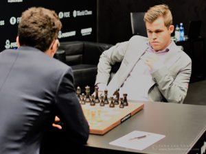 Magnus Carlsen faces Fabiano Caruana over the board at the start of round 5 of the FIDE World Chess Championship. Photograph by John Lee Shaw © www.hotoffthechess.com.